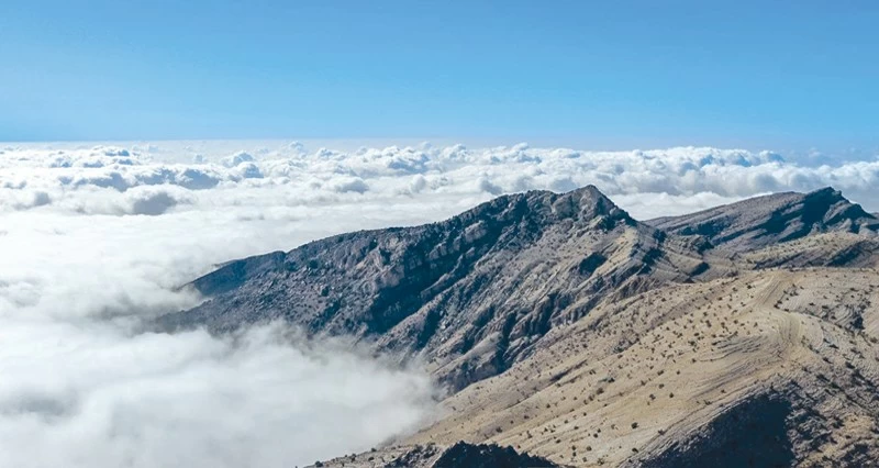 لقطة مميزة للضباب الكثيف يعانق جبال ولاية الجبل الأخضر بمحافظة الداخلية