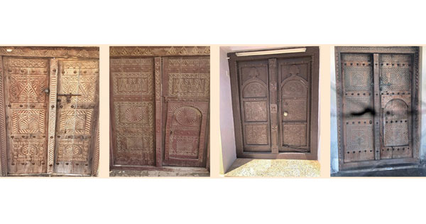 أبواب خشبية شامخة تعكس هندسة وفن الإنسان العماني